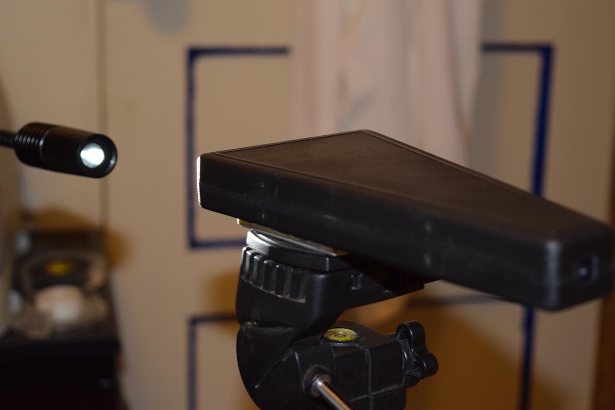 spectroscope mounted on a tripod looking at an LED gooseneck